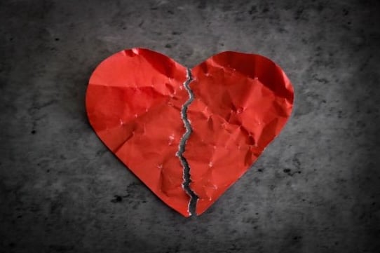 A paper heart broken in half.