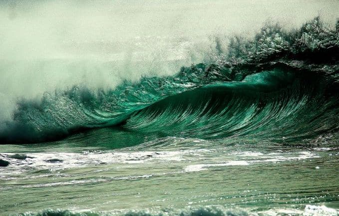 A tidal wave crashing on a beach.